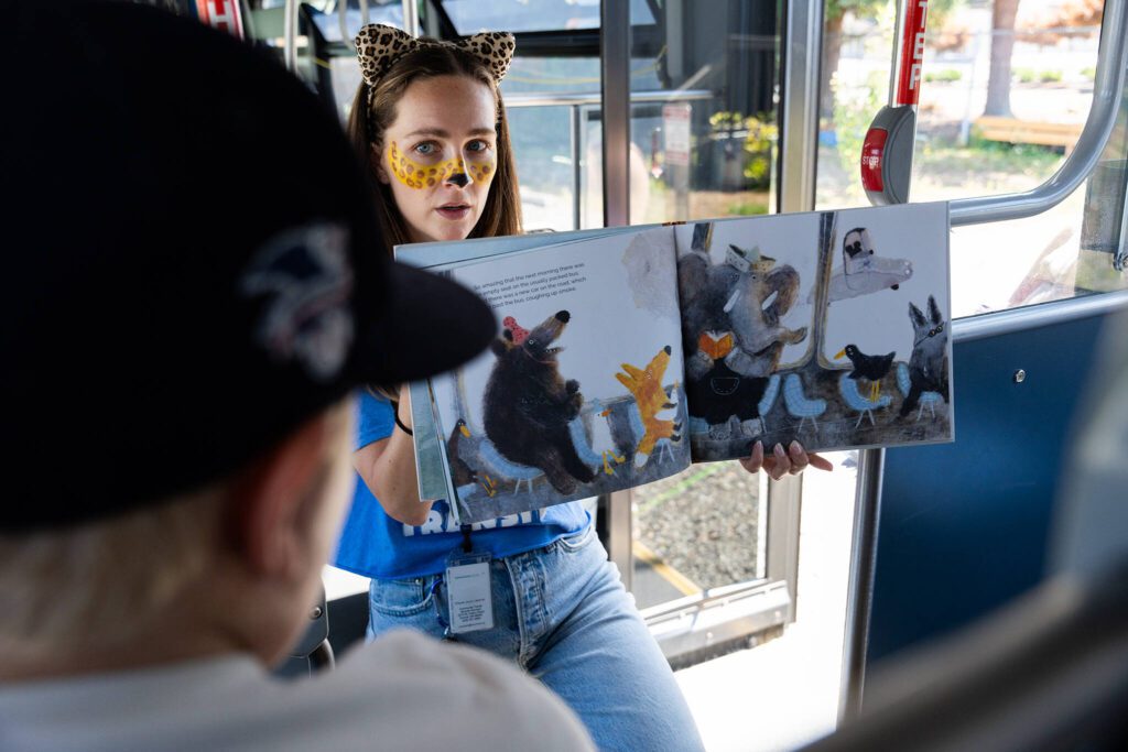 Natalie Lawrence reads a story at a ‘Transit Tales’ event on Wednesday, Aug. 20 in Smokey Point, Washington. (Will Geschke / The Herald)
