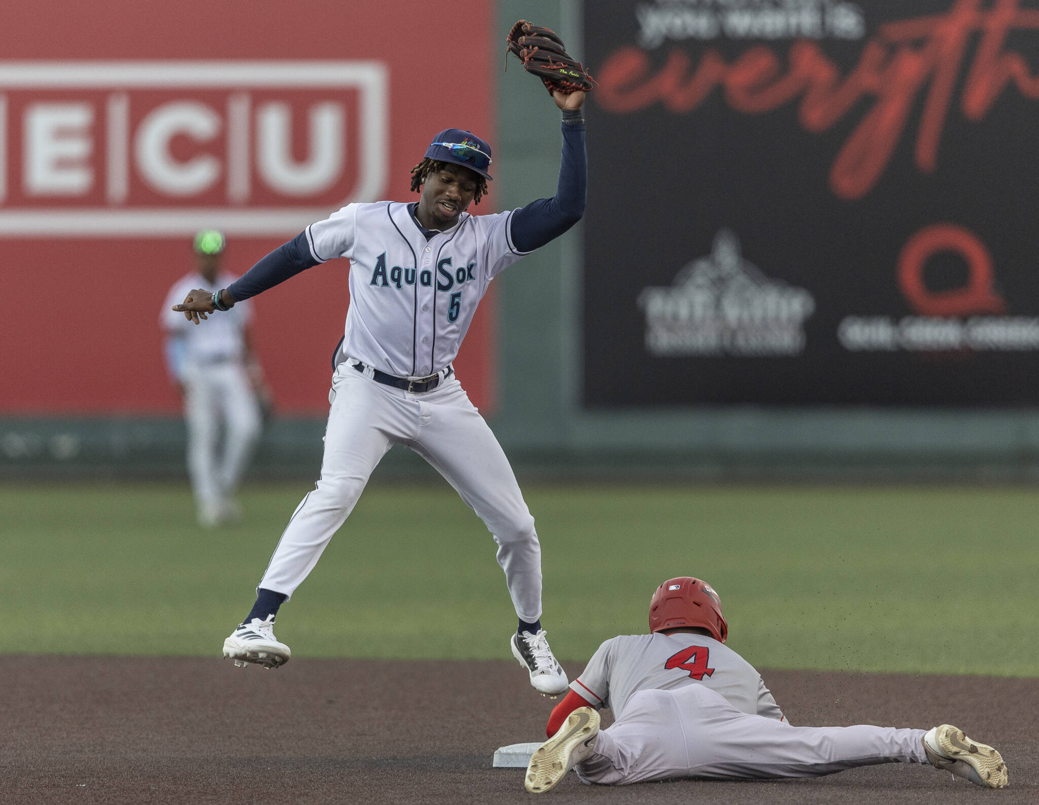 Everett AquaSox infielder Felnin Celesten leaps in the air to catch a throw to second base during the game against the Spokane Indians on Tuesday, Aug. 19, 2025 in Everett, Washington. (Olivia Vanni / The Herald)