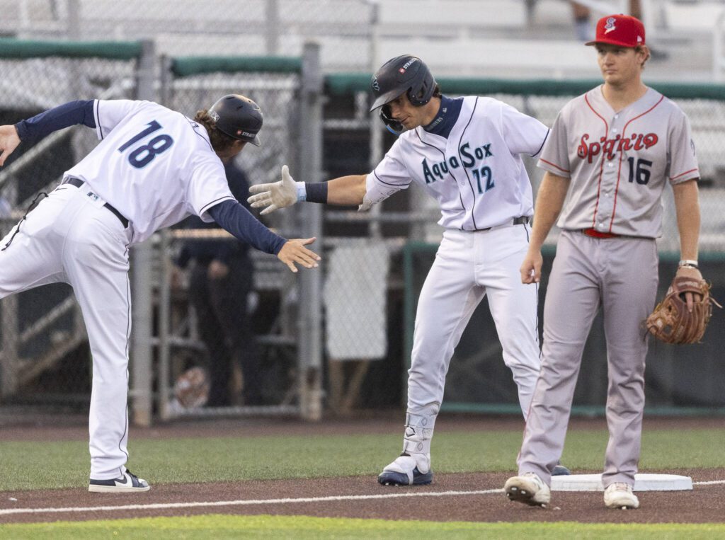 Everett AquaSox infielder Charlie Pagliarini gets a high five after getting a triple during the game against the Spokane Indians on Tuesday, Aug. 19, 2025 in Everett, Washington. (Olivia Vanni / The Herald)
