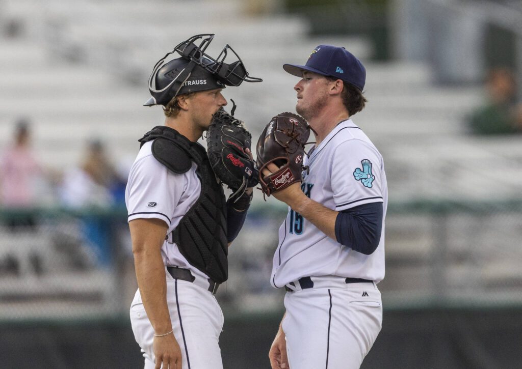 Everett AquaSox pitcher Ryan Hawks talks with Everett AquaSox catcher Josh Caron during the game against the Spokane Indians on Tuesday, Aug. 19, 2025 in Everett, Washington. (Olivia Vanni / The Herald)
