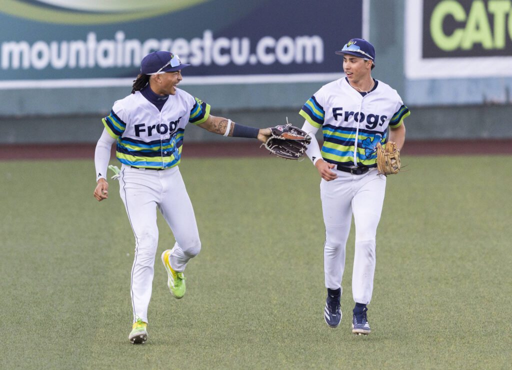 Everett AquaSox outfielder Tai Peete and Everett AquaSox outfielder Jonny Farmelo talk as they run in from the outfield between innings during the game against the Spokane Indians on Wednesday, Aug. 20, 2025 in Everett, Washington. (Olivia Vanni / The Herald)
