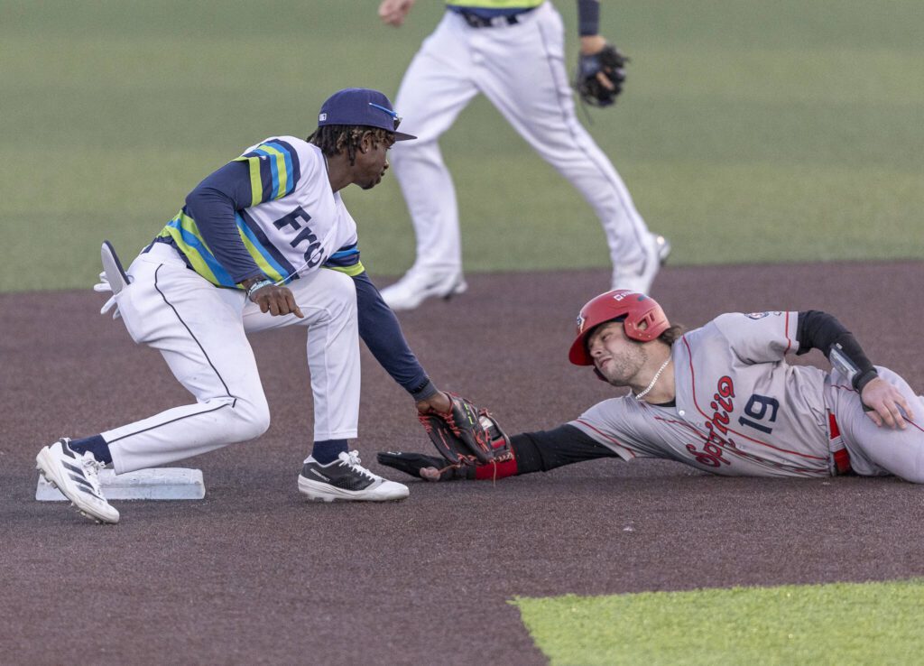Everett AquaSox infielder Felnin Celesten tags Spokane’s Cole Messina as he slides into second base during the game on Wednesday, Aug. 20, 2025 in Everett, Washington. (Olivia Vanni / The Herald)

