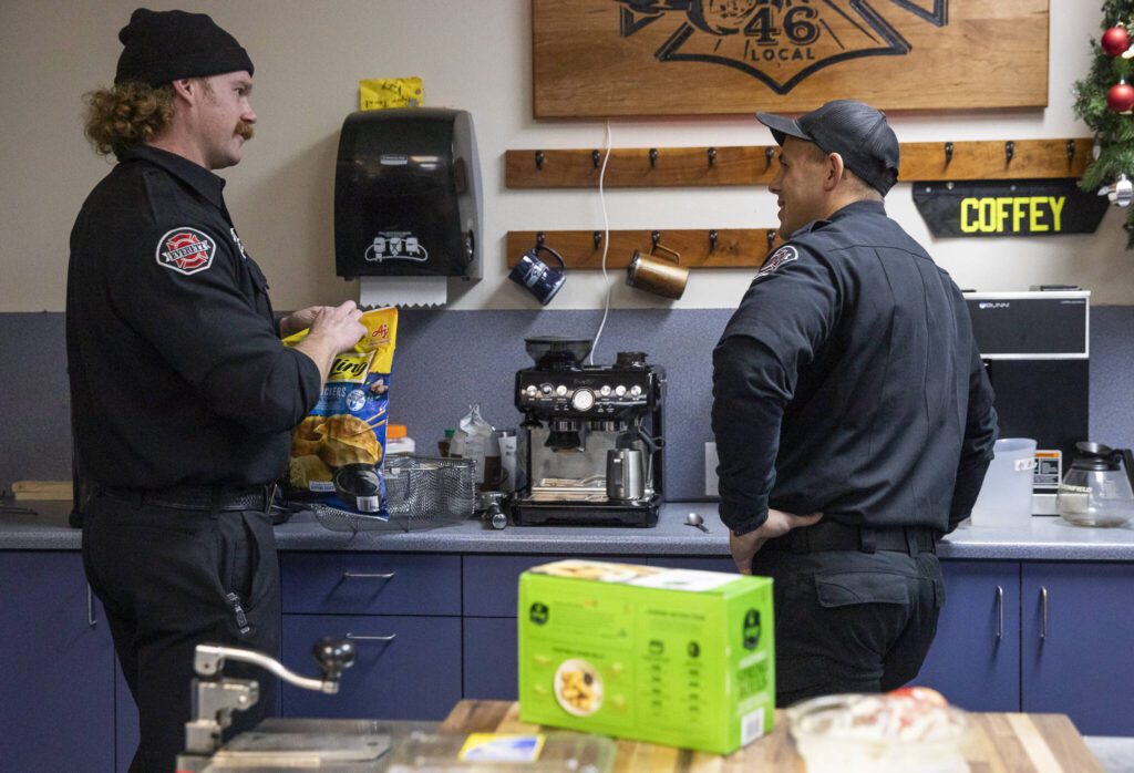 Ryan Fromm and Mike Aquino chat in the kitchen of Fire Station One on Tuesday, Dec. 10, 2024 in Everett, Washington. (Olivia Vanni / The Herald)
Firefighters Ryan Fromm and Mike Aquino chat in the kitchen of Everett Fire Station One. (Olivia Vanni / The Herald)
