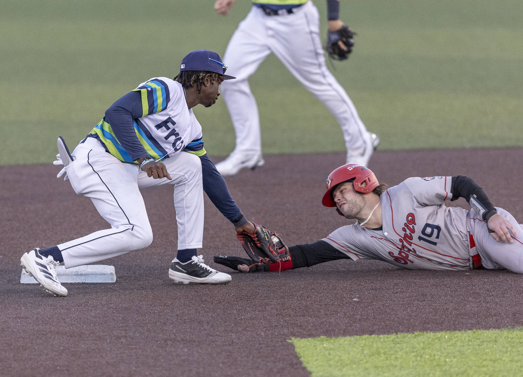 Everett AquaSox infielder Felnin Celesten tags Spokane’s Cole Messina as he slide into second base during the game on Wednesday, Aug. 20, 2025 in Everett, Washington. (Olivia Vanni / The Herald)