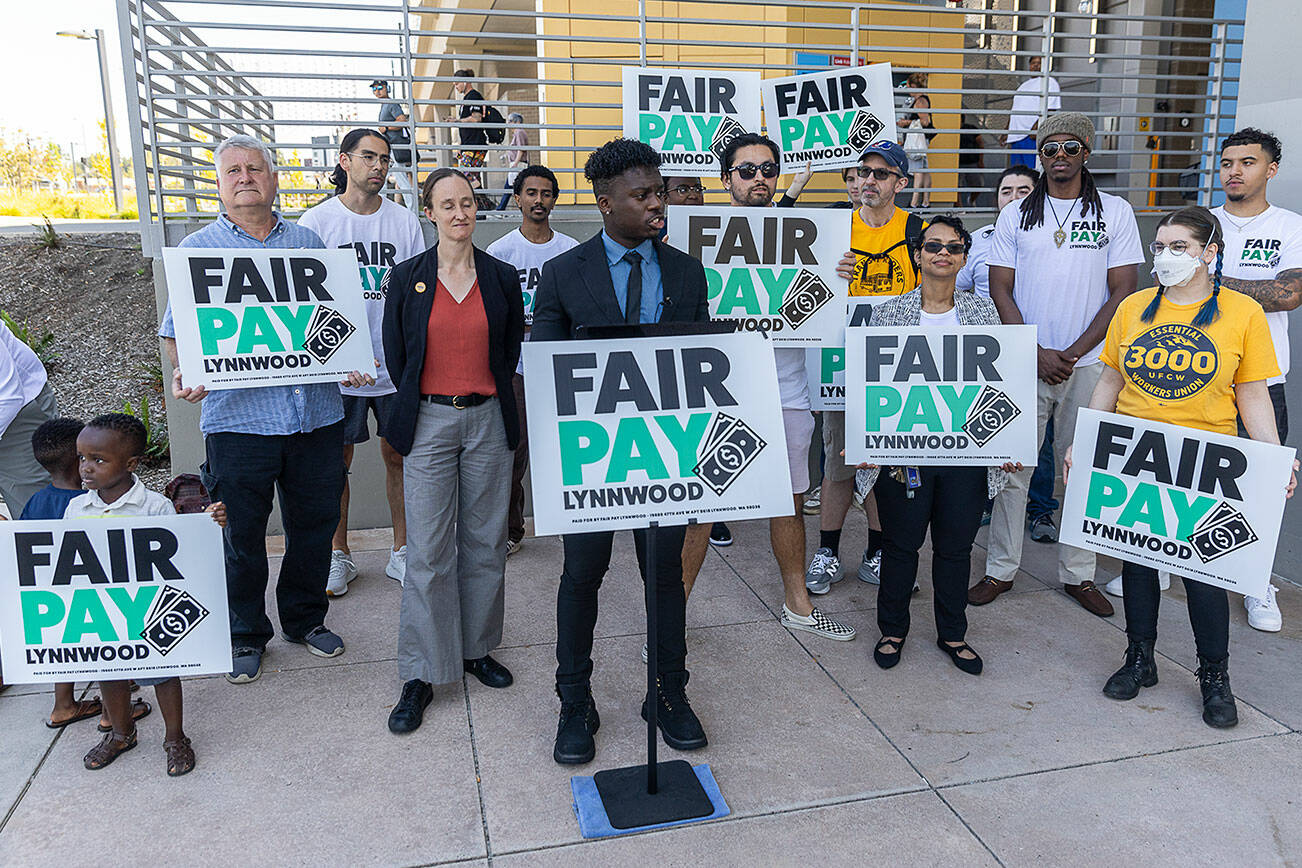 People gather for a Fair Pay Lynnwood rally while Lynnwood City Council Vice President Josh Binda speaks on Monday, Aug. 25, 2025 in Lynnwood, Washington. (Olivia Vanni / The Herald)