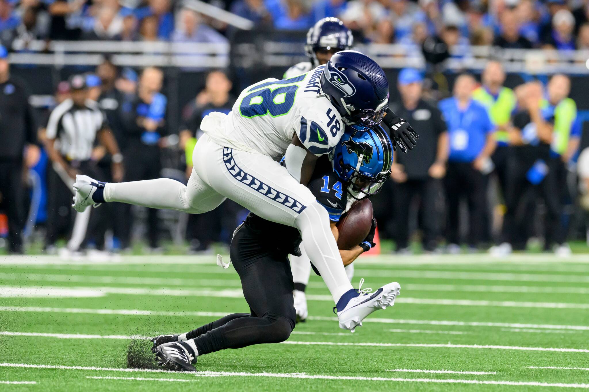 Lions wide receiver Amon-Ra St. Brown is tackled by Seahawks linebacker Tyrice Knight during a game in 2024. (David Guralnick / Detroit News / Tribune News Services)