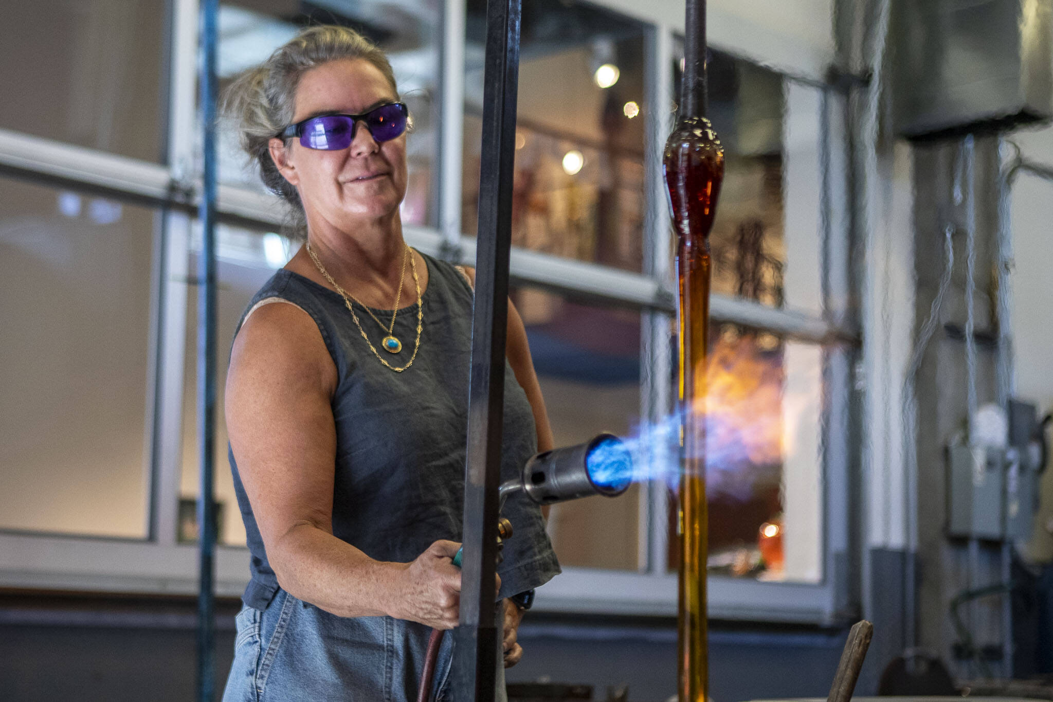 Merrilee Moore works with glass at Schack Art Center in Everett, Washington on Friday, Sept. 15, 2023. (Annie Barker / The Herald)