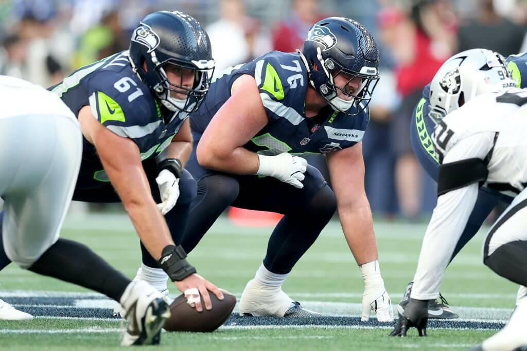Seahawks OL Jalen Sundell (61) and Grey Zabel (76) line up before a snap against the Las Vegas Raiders in a preseason game on Thursday, Aug. 7, 2025 at Lumen Field in Seattle, Wash. (Steph Chambers / The Seattle Times / Getty Images)