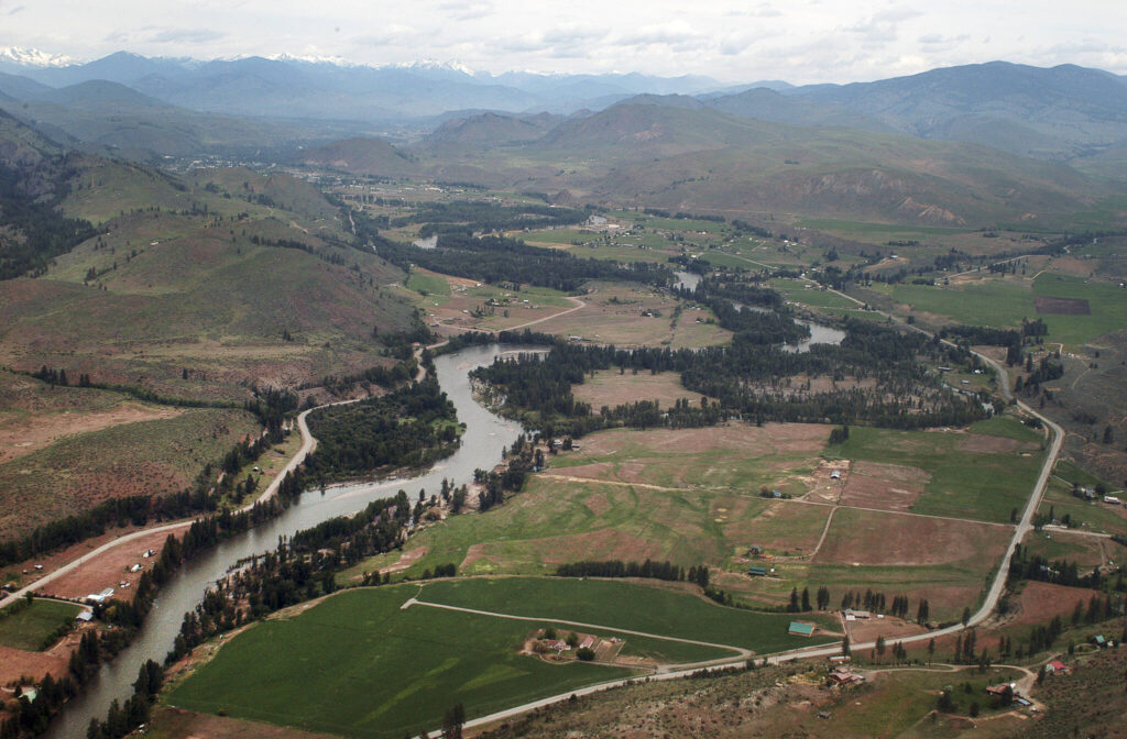 This 2007 aerial view of the Methow River is seen through the window of a small plane on a flight that originated from Twisp Municipal Airport. Looking north toward Twisp, about five miles up the road, the river is sandwiched between Highway 153 on the right and the Twisp-Carlton road on the left. (Sue Misao)
