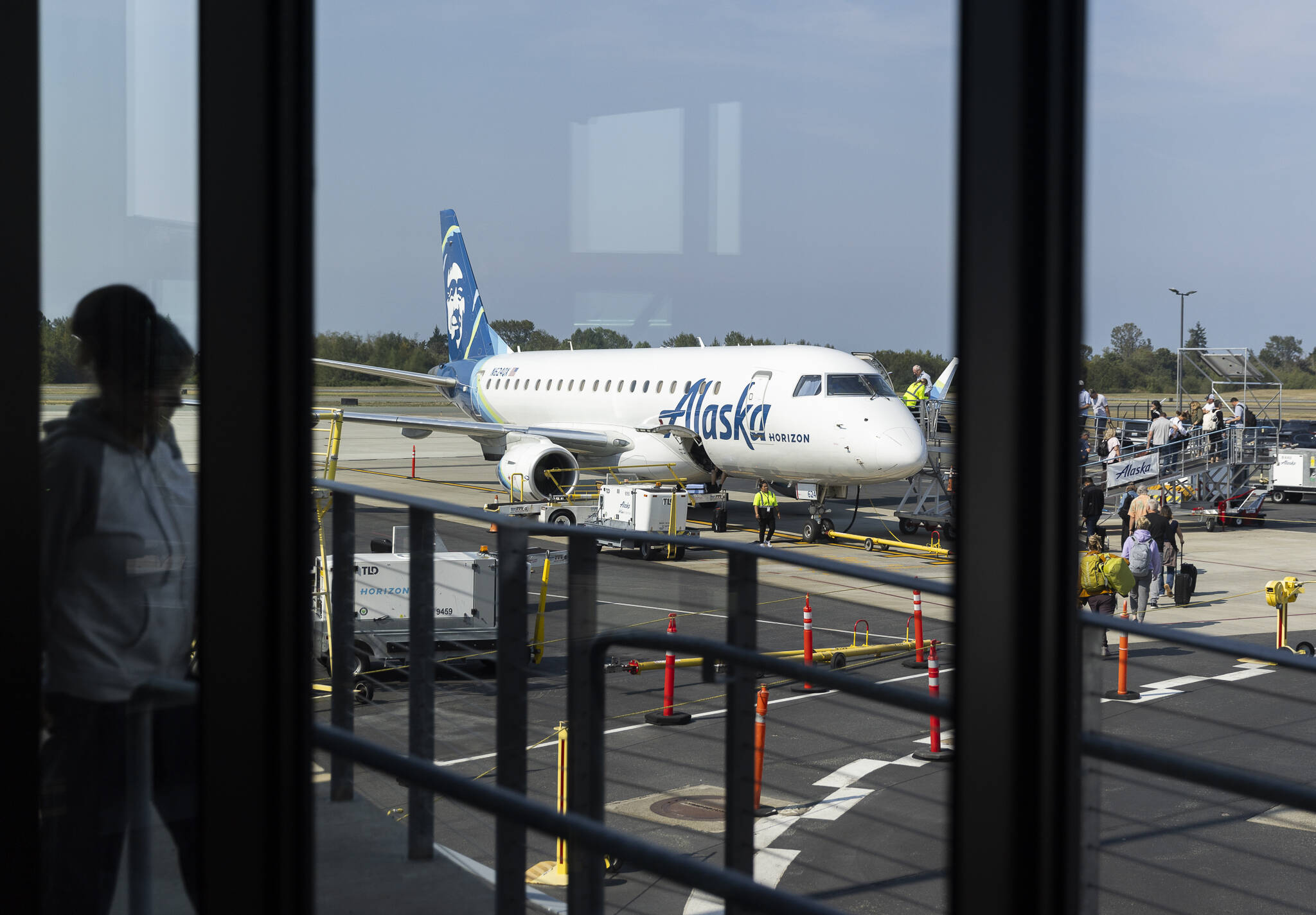 People board a plane at Paine Field Airport on Wednesday, Sept. 3, 2025 in Everett, Washington. (Olivia Vanni / The Herald)