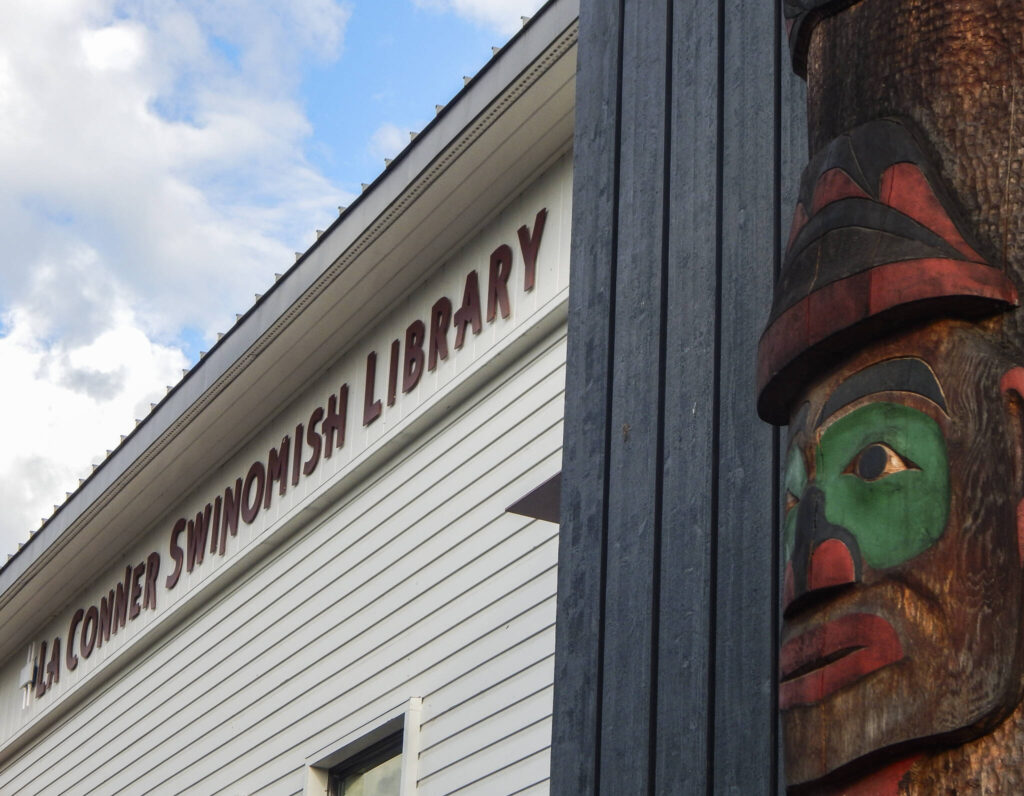A story pole by Swinomish artist Kevin Paul and son-in-law Camas Logue welcomes visitors to the La Conner-Swinomish Library. (Jon Bauer / The Herald)
