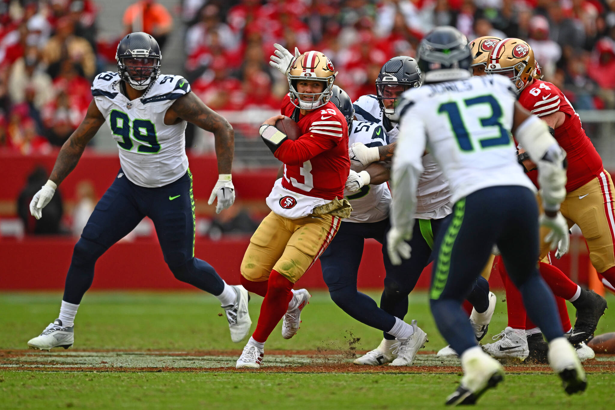 San Francisco 49ers quarterback Brock Purdy (13) runs from the Seattle Seahawks defense in the third quarter of their NFL game at Levi's Stadium in Santa Clara, Calif., on Sunday, Nov. 17, 2024. (Jose Carlos Fajardo / Bay Area News Group / Tribune News Services)