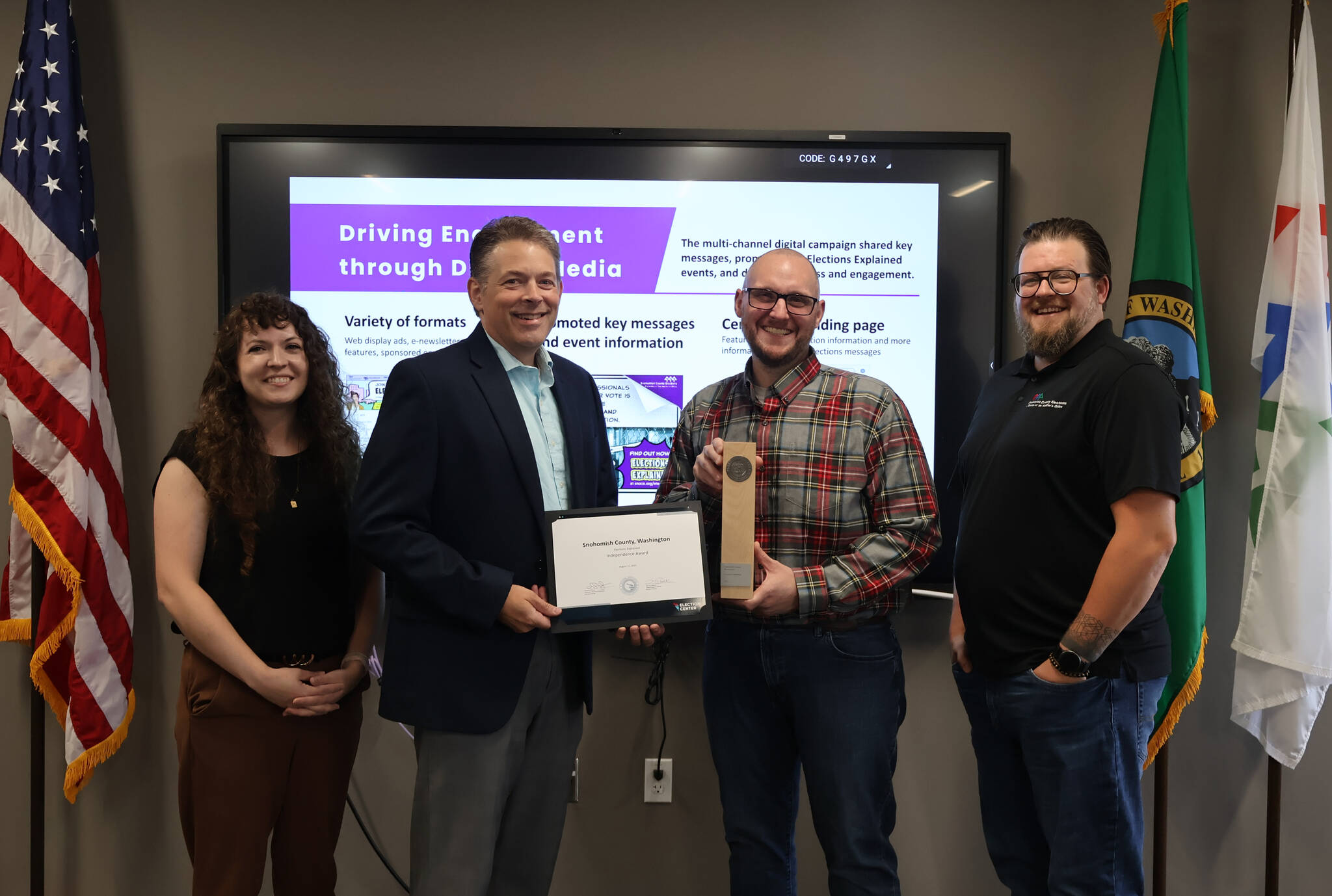 Provided photo
Snohomish County Auditor Garth Fell (middle left) and Elections division staff stand with the “Independence Award” from the National Association of Election Officials.