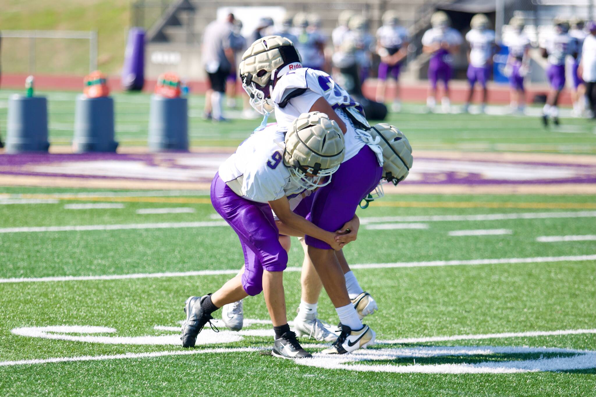 A trio of Lake Stevens football players participate in a tackling drill during a practice at Lake Stevens High School on Sept. 2, 2025. (Joe Pohoryles / The Herald)