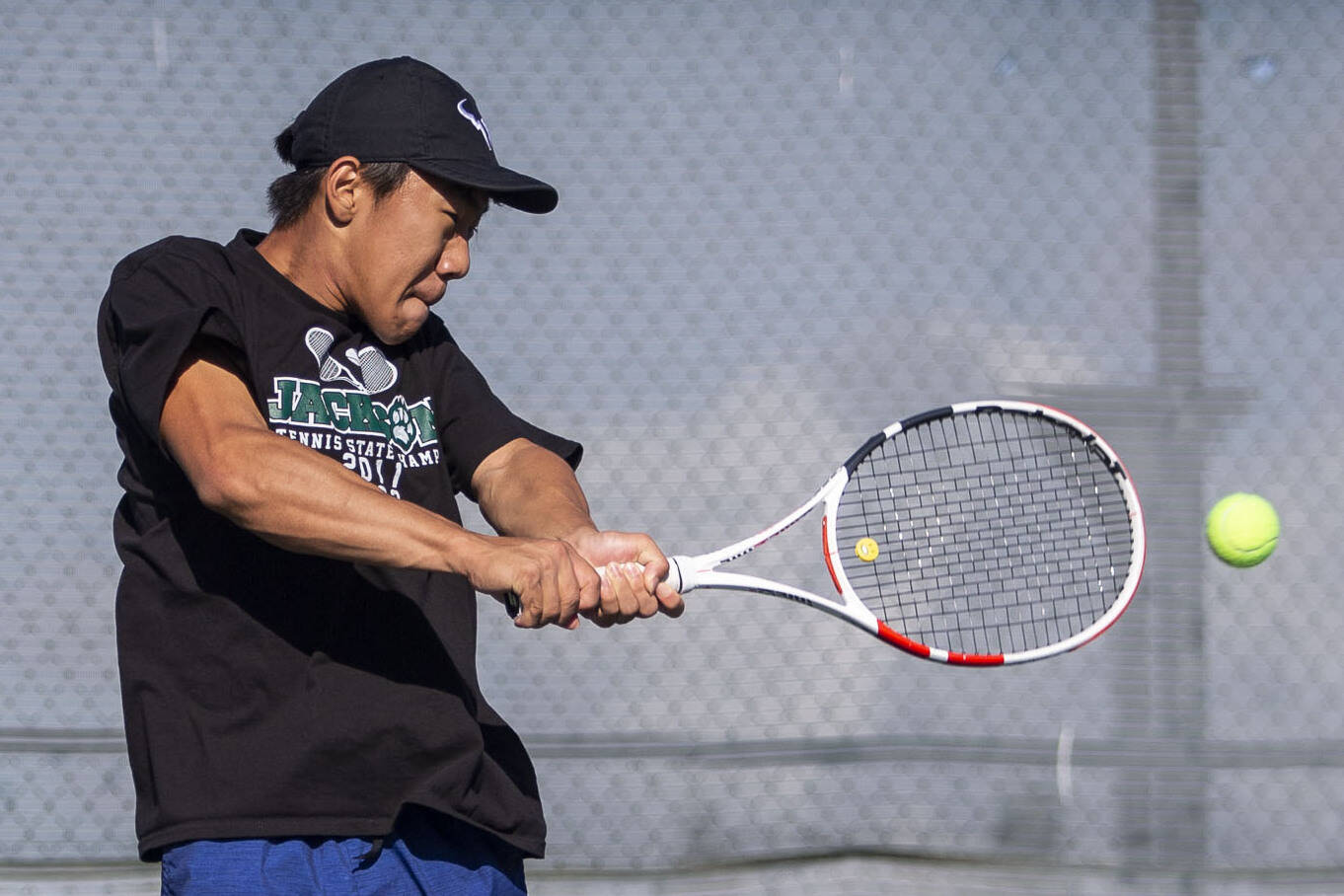 David Song jumps in the air to hit the ball during the district championship singles match on Thursday, Oct. 24, 2024 in Snohomish, Washington. (Olivia Vanni / The Herald)