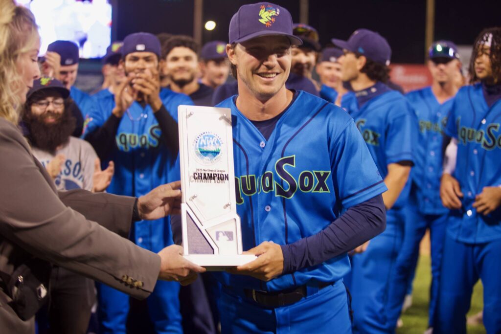 AquaSox manager Zach Vincej is presented the Northwest League Championship trophy following Everett’s series-clinching 6-3 win in Game 4 against the Eugene Emeralds at Funko Field on Sept. 13, 2025. (Joe Pohoryles / The Herald)
