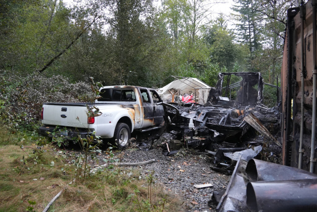 Fire that engulfed a mobile home on Sunday, Sep. 14, 2025, extended to a nearby pickup truck and CONEX box in Monroe. (Snohomish Regional Fire and Rescue)
