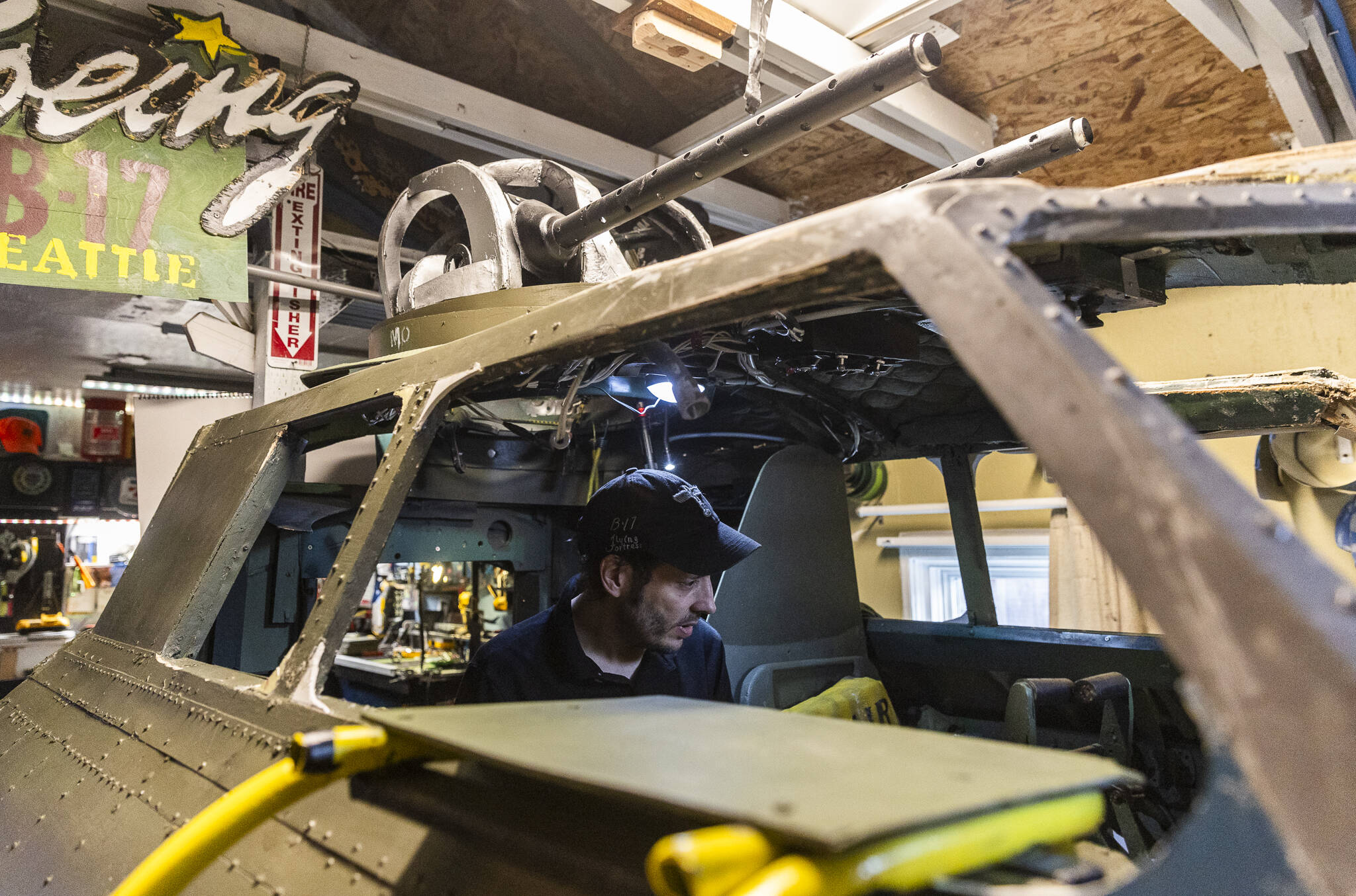 Thatcher Johnson inside the full-size B-17 cockpit he is building in his garage from scratch based on Boeing’s plans on Sept. 23, 2025 in Everett, Washington. (Olivia Vanni / The Herald)