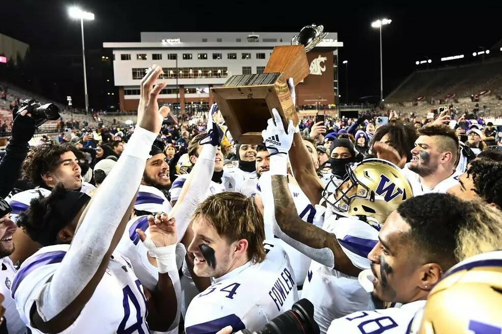Washington Huskies football players celebrate after winning the Apple Cup at Martin Stadium in Pullman, Washington on Saturday, Nov. 26, 2022. (Photo courtesy of Washington Athletics)