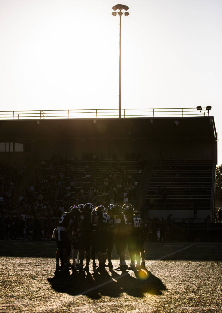 Shorewood players huddle before the snap during the game against Monroe on Friday, Sept. 19, 2025 in Shoreline, Washington. (Olivia Vanni / The Herald)
