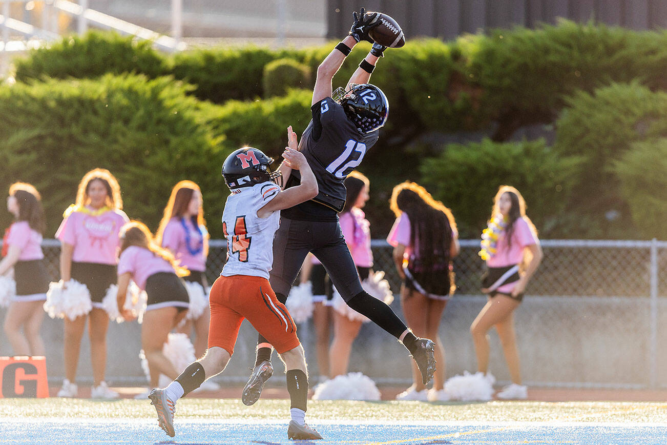 Shorewood’s Lukas Wanke leaps in the air above Monroe’s Josh Ward to make a catch for a touchdown during the game on Friday, Sept. 19, 2025 in Shoreline, Washington. (Olivia Vanni / The Herald)