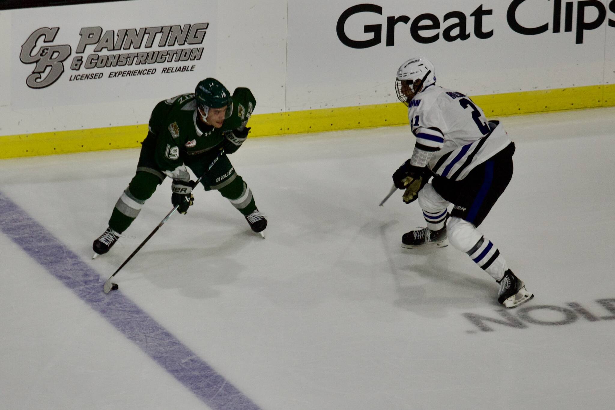 Silvertips forward Zackary Shantz looks for a pass around Wild defenseman Darian Rolsing during Everett's 4-3 shootout win against Wenatchee at Angel of the Winds Arena on Sept. 20, 2025. Shantz had a natural hat trick to overcome a 3-0 deficit and force overtime. (Joe Pohoryles / The Herald)