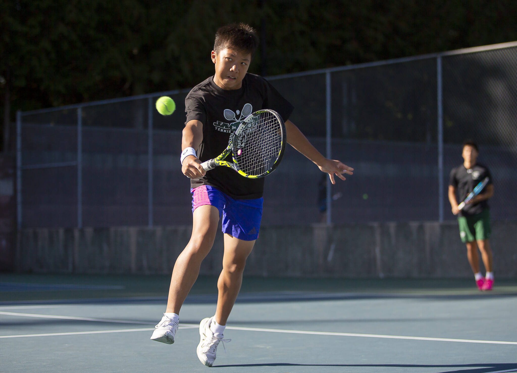 Jackon’s Samuel Song hits the ball during a doubles match against Kamiak on Monday, Sept. 30, 2024 in Mill Creek. (Olivia Vanni / The Herald)
