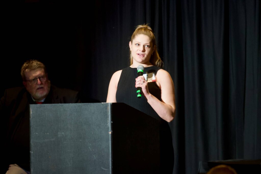 Sarah (Schireman) Linse gives her induction speech during the Snohomish County Sports Hall of Fame Banquet at the Edward D. Hansen Conference Center in Everett on Sept. 24, 2025. (Joe Pohoryles / The Herald)
