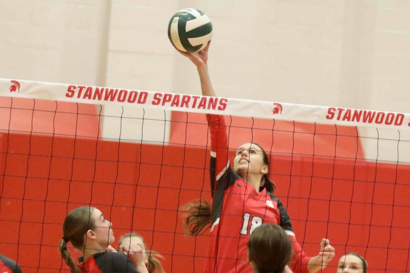 Stanwood outside hitter Whitney Longspaugh tips the ball during a District 1 3A quarterfinals match against Monroe in Stanwood, Wash., on Tuesday, Nov. 12, 2024. (Taras McCurdie / The Herald)
