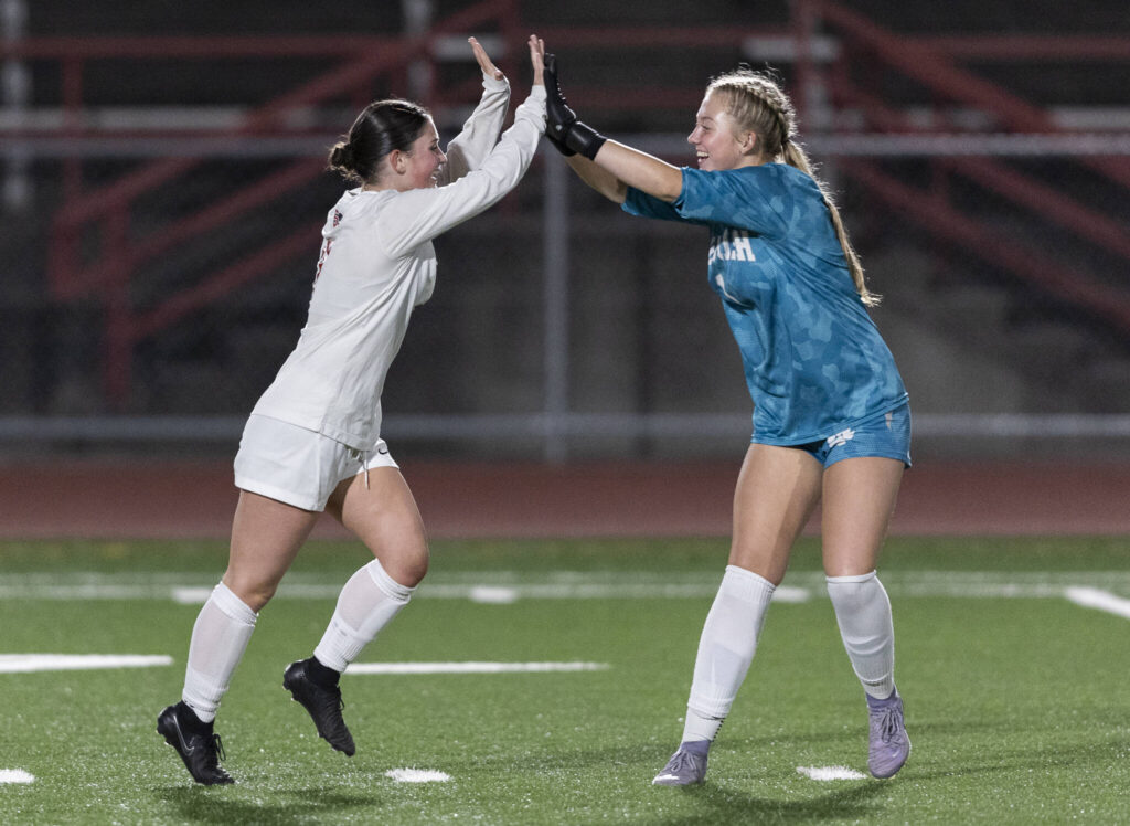 Snohomish&rsquo;s Jo Cort high-fives Snohomish&rsquo;s Addison Carter after scoring during the game against Stanwood on Sept. 25, 2025 in Stanwood, Washington. (Olivia Vanni / The Herald)

