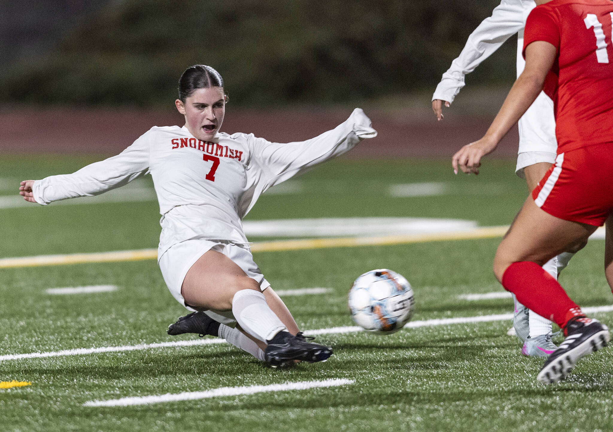 Snohomish’s Jo Cort takes a shot on goal as she slides to the ground in the goal box during the game against Stanwood on Sept. 25, 2025 in Stanwood, Washington. (Olivia Vanni / The Herald)