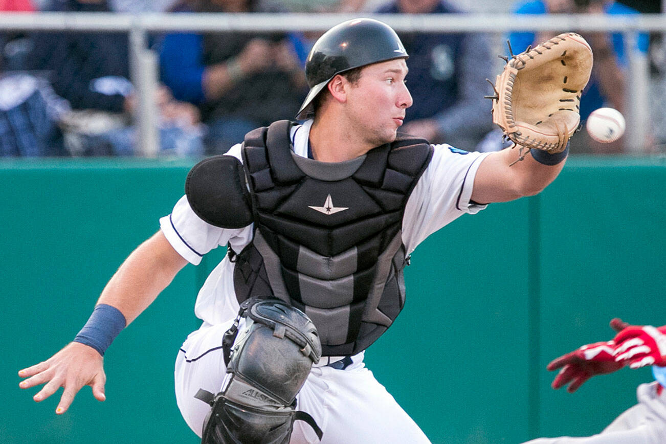 Indians' J.P. Martinez beats the throw to AquaSox's Cal Raleigh for a run in the first inning Wednesday evening at Everett Memorial Stadium in Everett on September 5, 2018.  (Kevin Clark / The Herald)