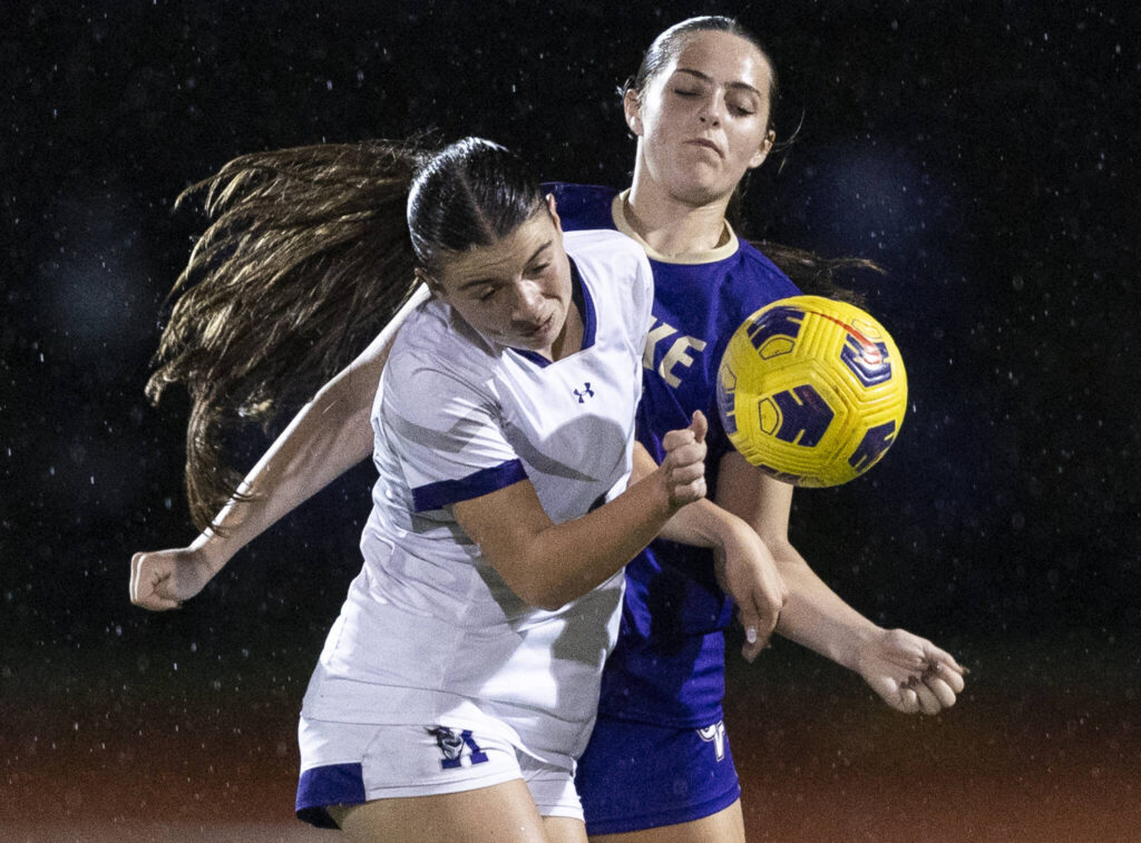 Kamiak’s Ella Henriksen and Lake Stevens’ Shelby Wallace try and trap the ball during the game on Sept. 30, 2025 in Lake Stevens, Washington. (Olivia Vanni / The Herald)
