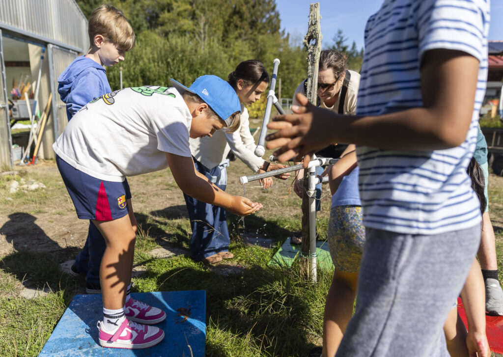 Dylan Black washes his hands before going to pick vegetables in the garden during class at South Whidbey Elementary School on Sept. 22, 2025 in Langley, Washington. (Olivia Vanni / The Herald)
