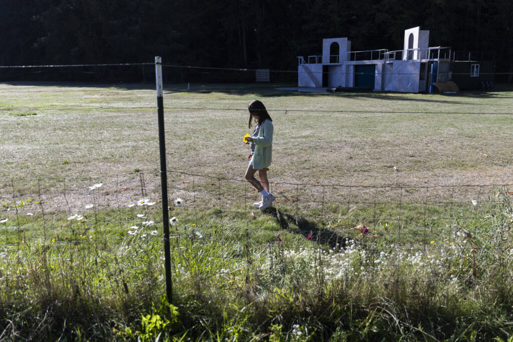 Anders Sheritt walks with fresh cut flowers during class at South Whidbey Elementary School on Sept. 22, 2025 in Langley, Washington. (Olivia Vanni / The Herald)
