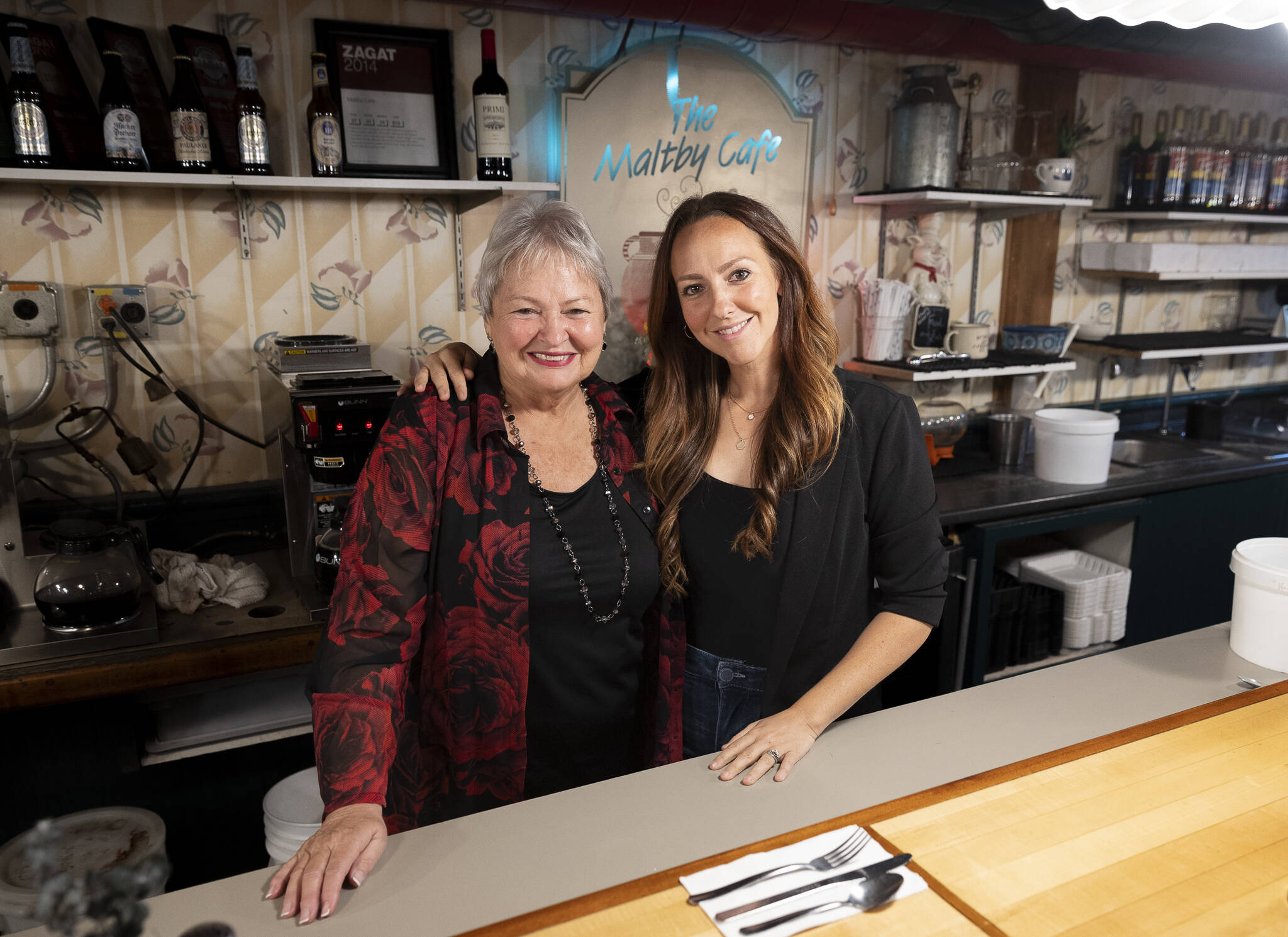 Keesha Laws, right, with mom and co-owner Tana Baumler, left, behind the bar top inside The Maltby Cafe on Sept. 29, 2025 in Snohomish, Washington. (Olivia Vanni / The Herald)