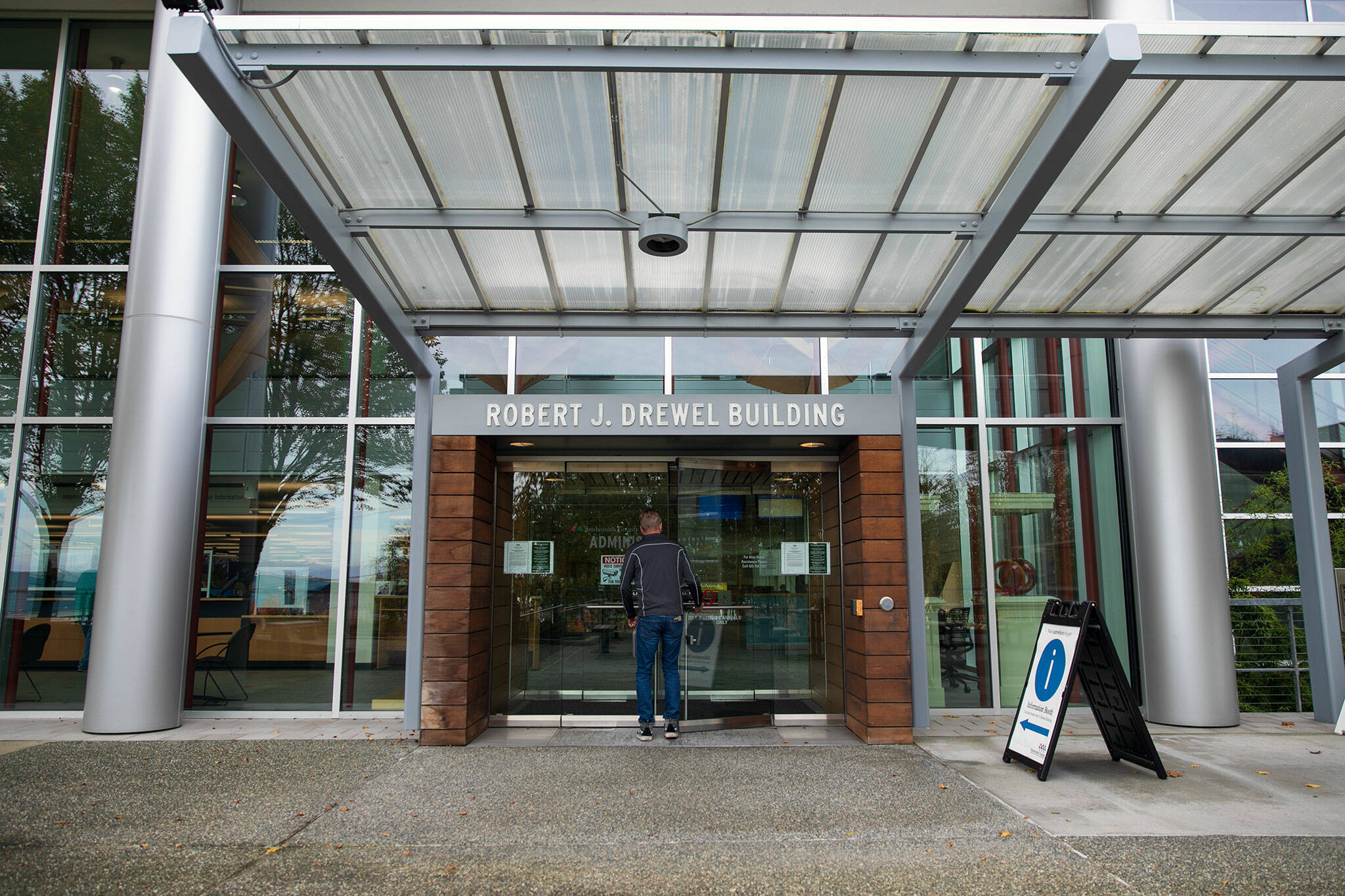 A person enters the Robert J. Drewel Building on Friday, Nov. 3, 2023, at the county campus in downtown Everett, Washington. (Ryan Berry / The Herald)