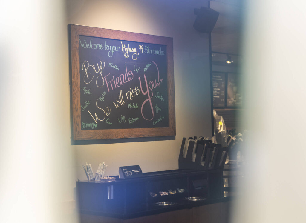 A sign with a goodbye message signed by store employees is visible through a space between paper covering the windows of a recently closed Starbucks on the corner of Highway 99 and 220th Street SW on Oct. 1, 2025 in Edmonds, Washington. (Olivia Vanni / The Herald)

