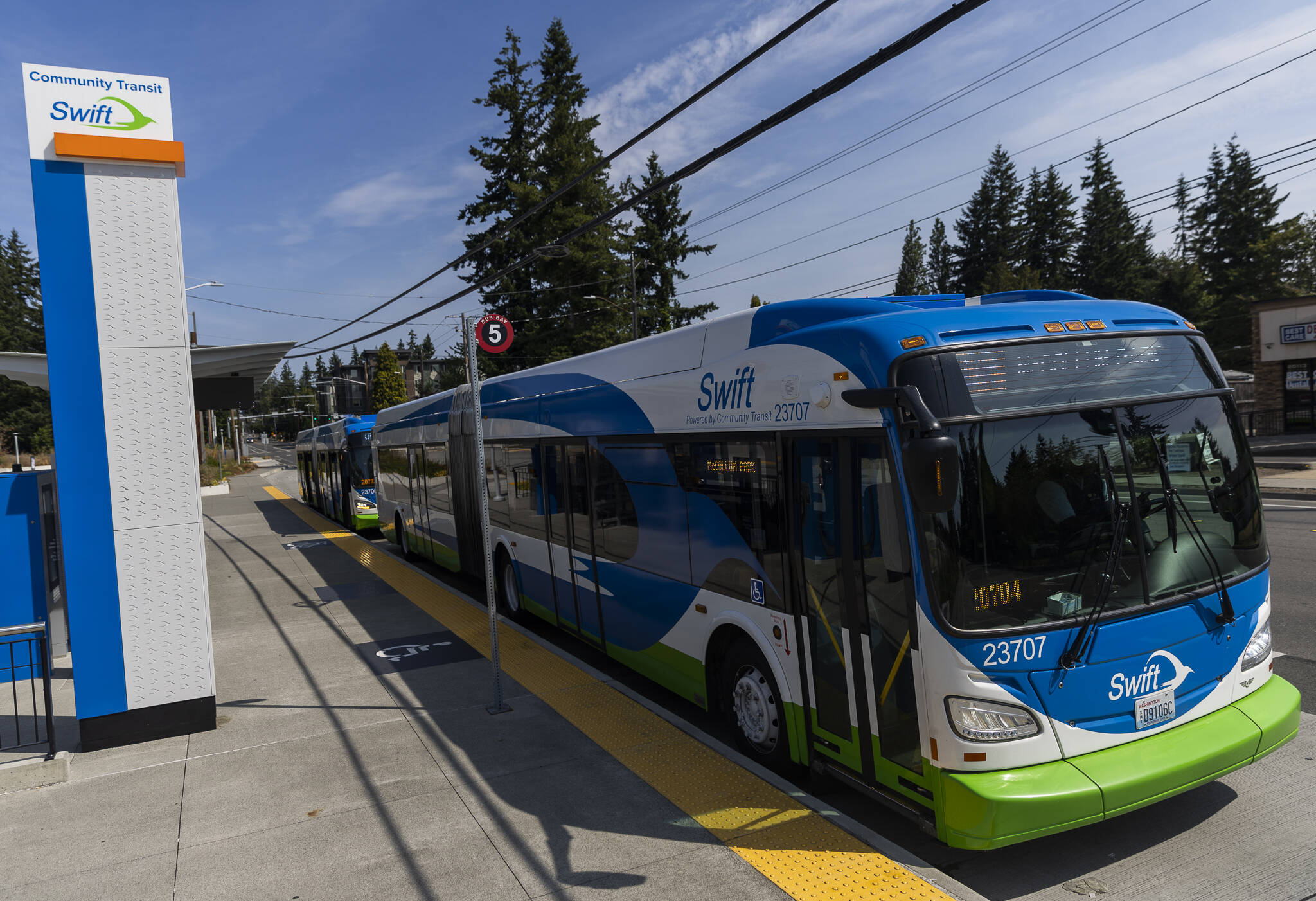 Two Swift Orange Line buses waits at the Edmonds College Transit Center on Friday, Aug. 1, 2025 in Lynnwood, Washington. (Olivia Vanni / The Herald)