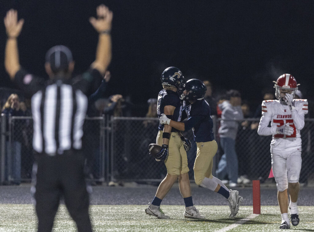Arlington’s Shane Wohlleben celebrates after scoring a touchdown during the game against Stanwood son Oct. 10, 2025 in Arlington, Washington. (Olivia Vanni / The Herald)
