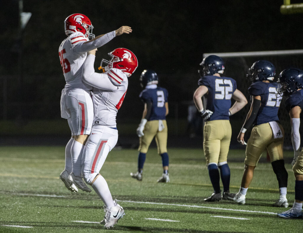 Stanwood’s Eben Bland Jr is lifted in the air in celebration after scoring a touchdown during the game against Arlington on Oct. 10, 2025 in Arlington, Washington. (Olivia Vanni / The Herald)

