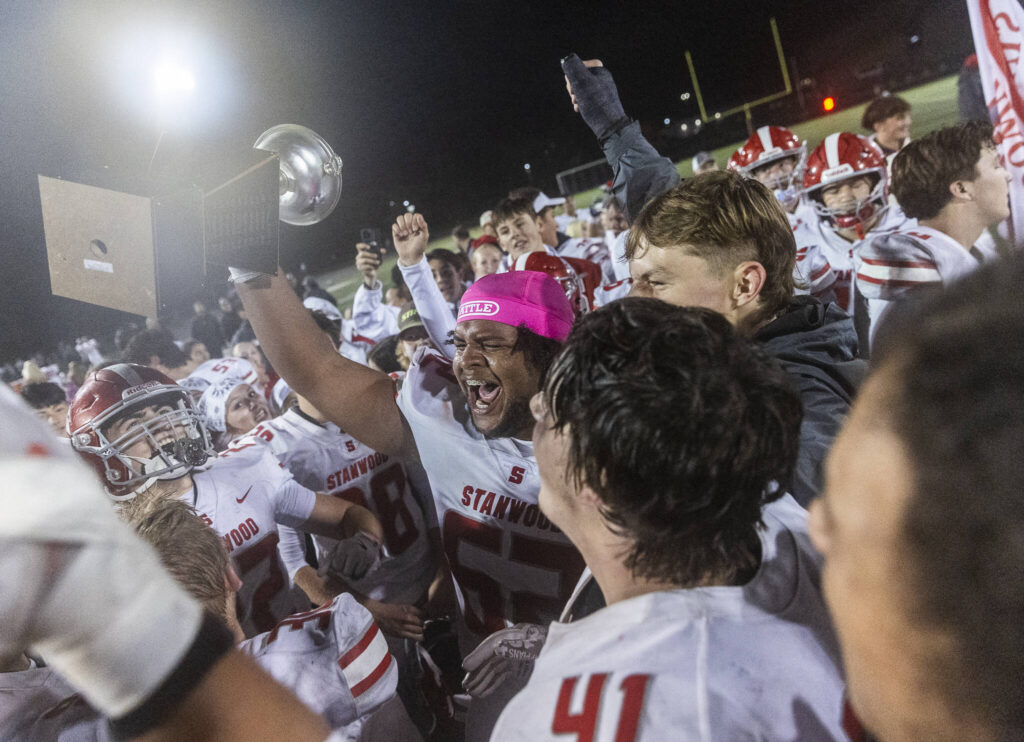 Stanwood’s Memphys Ellis yells while holding the Stilly Cup after beating Arlington on Oct. 10, 2025 in Arlington, Washington. (Olivia Vanni / The Herald)
