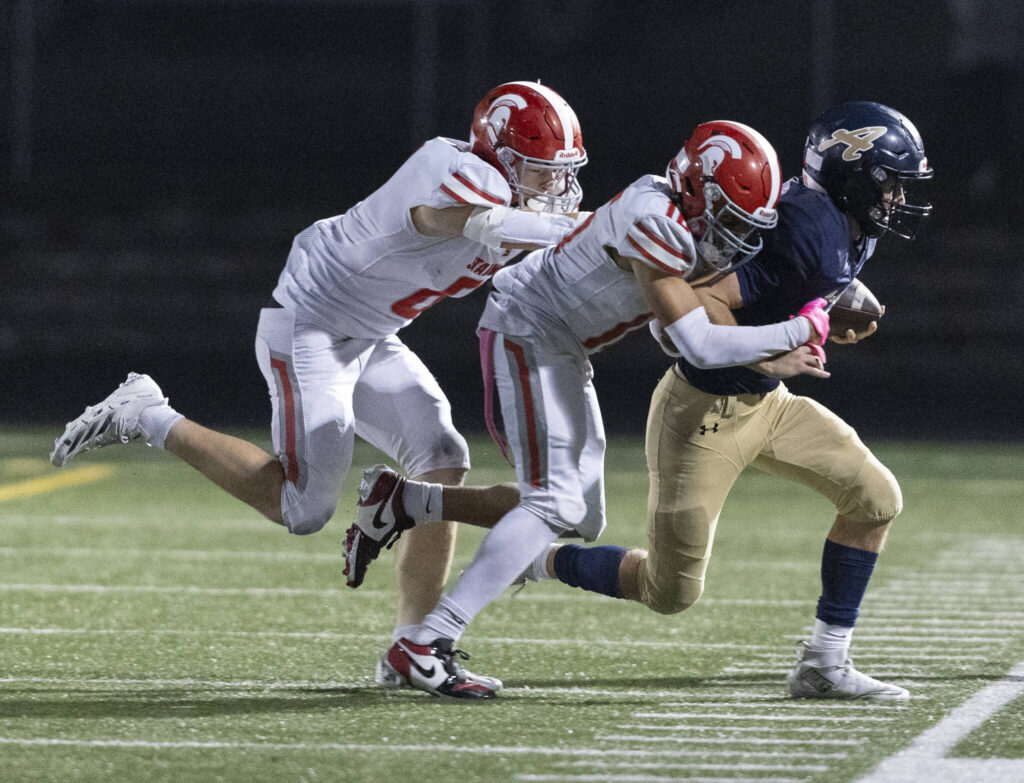 Arlington’s Linkin Currie is tackled out of bounds during the game against Stanwood on Oct. 10, 2025 in Arlington, Washington. (Olivia Vanni / The Herald)
