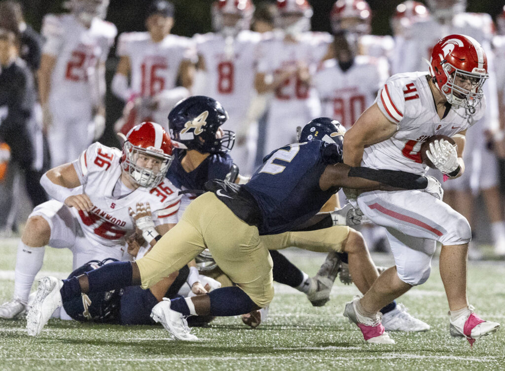 Stanwood’s Silas Turpin is tackled during the game against Arlington on Oct. 10, 2025 in Arlington, Washington. (Olivia Vanni / The Herald)
