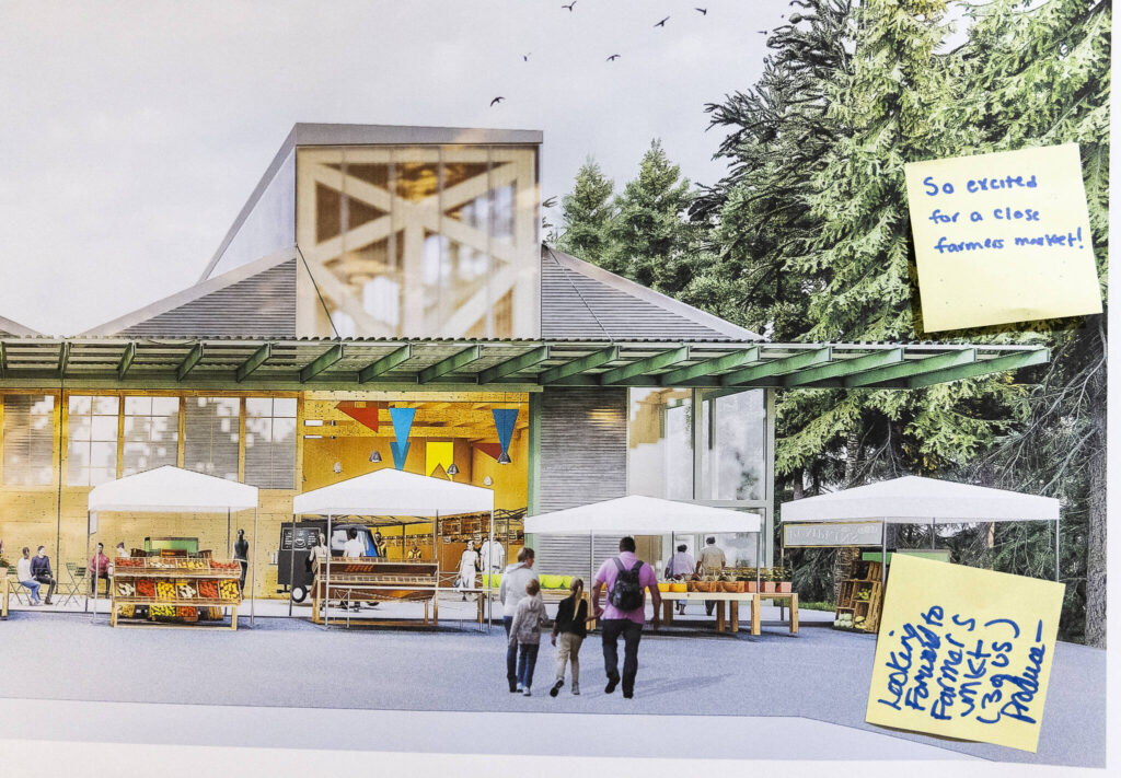 People leave notes on farmers market concept photos during an informational open house held at the Northwest Stream Center on Oct. 9, 2025 in Everett, Washington. (Olivia Vanni / The Herald)
