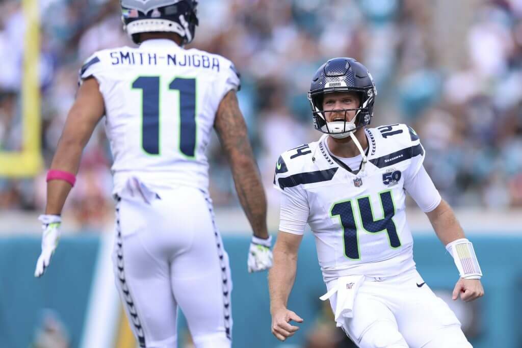 Seahawks receiver Jaxon Smith-Njigba (11) and quarterback Sam Darnold celebrate during a game against the Jacksonville Jaguars at EverBank Stadium on Sunday, Oct. 12, 2025. (The Athletic)