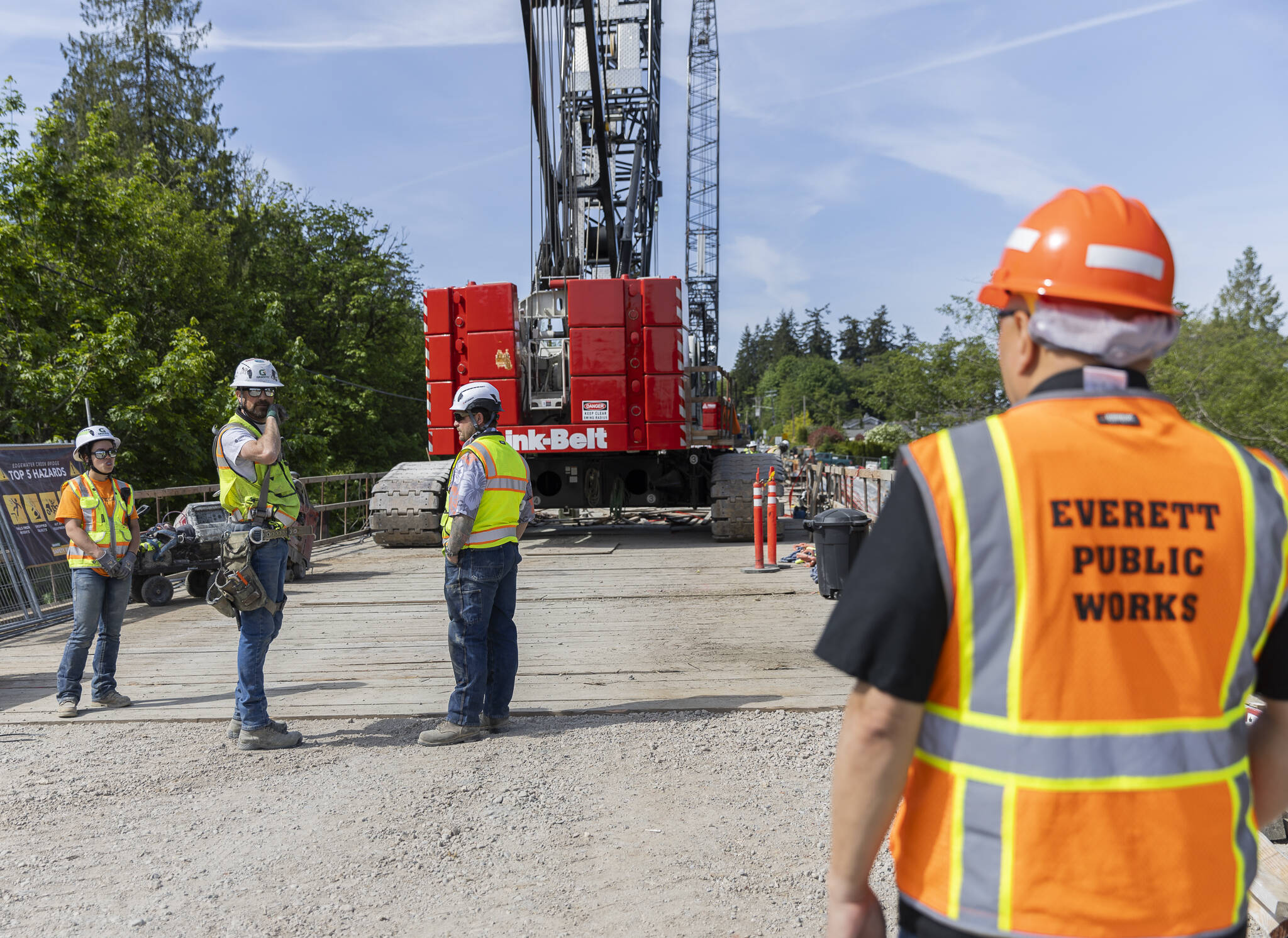 Edgewater Bridge construction workers talk as demolition continues on the bridge on Friday, May 9, 2025 in Everett, Washington. (Olivia Vanni / The Herald)