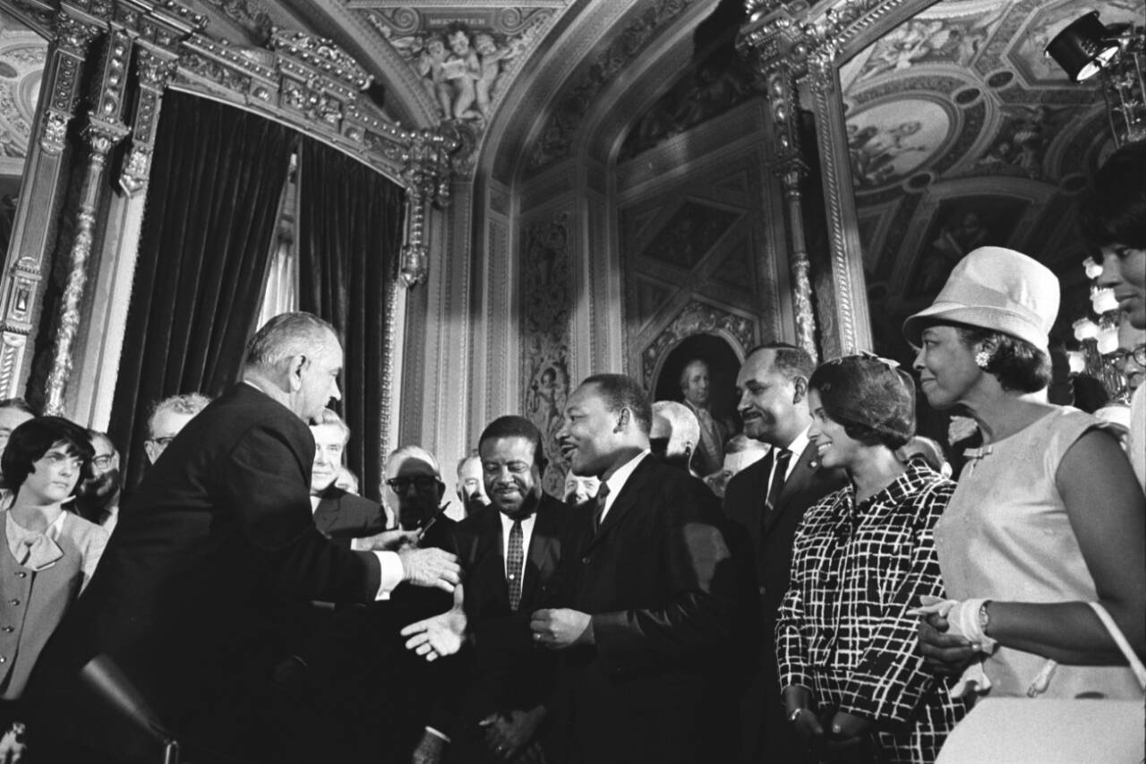 In an official White House photo, President Lyndon Johnson shakes hands with Dr. Martin Luther King Jr. after signing the Voting Rights Act of 1965, in Washington on Aug. 6, 1965. The Supreme Court has shown a willingness to chip away at the landmark civil rights legislation. A Louisiana case could unravel much of its remaining power. (Yoichi Okamoto / Lyndon B. Johnson Library via The New York Times)