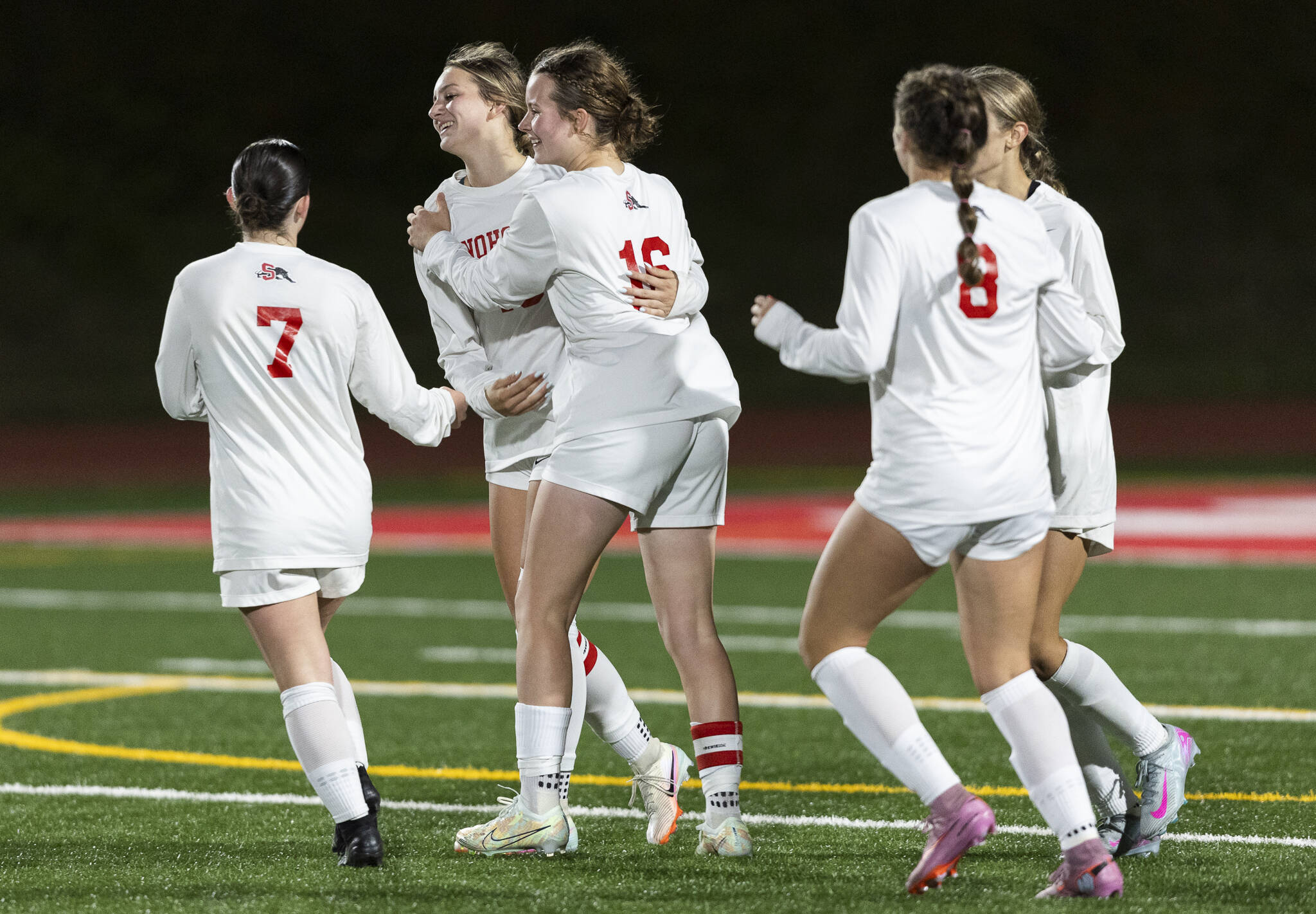 Snohomish’s Nevaeh Howerton hugs her teammates after scoring during the game against Stanwood on Sept. 25, 2025 in Stanwood, Washington. (Olivia Vanni / The Herald)