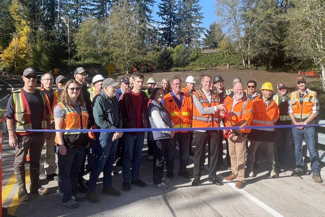 County Council member Nate Nehring cuts the ribbon with Executive Operations Officer Josh Dugan, celebrating on Oct. 21, 2025 with the crew that worked on the new Jordan Creek Bridge. (Provided photo)